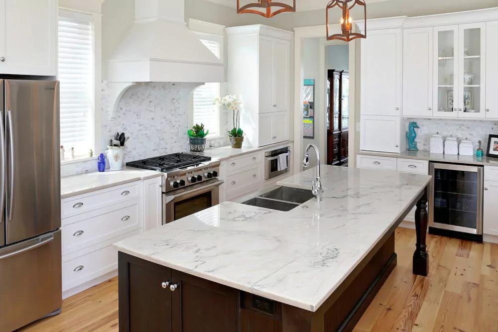 High-end kitchen remodel in Santa Barbara featuring custom cabinetry, stone countertops, modern appliances, and a large center island.